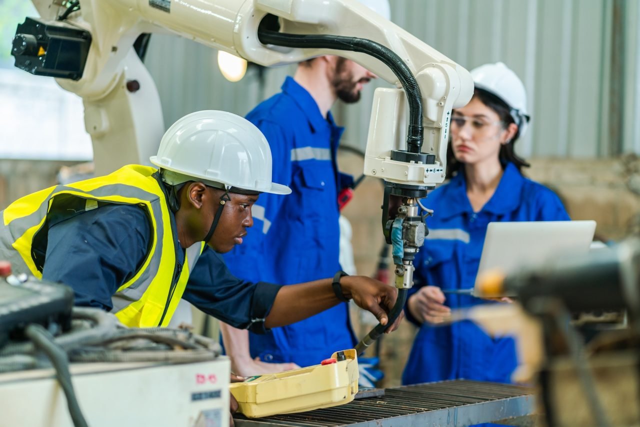 Robotics engineers testing industrial automation equipment