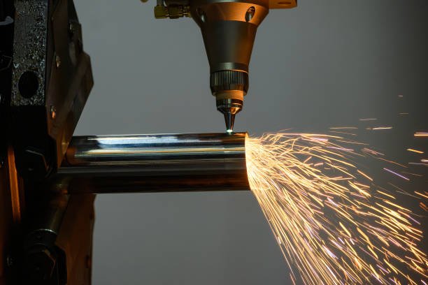 Close up scene the fiber laser cutting machine cut the stainless steel tube and sparkling light. The hi-technology sheet metal manufacturing process by laser cutting machine.