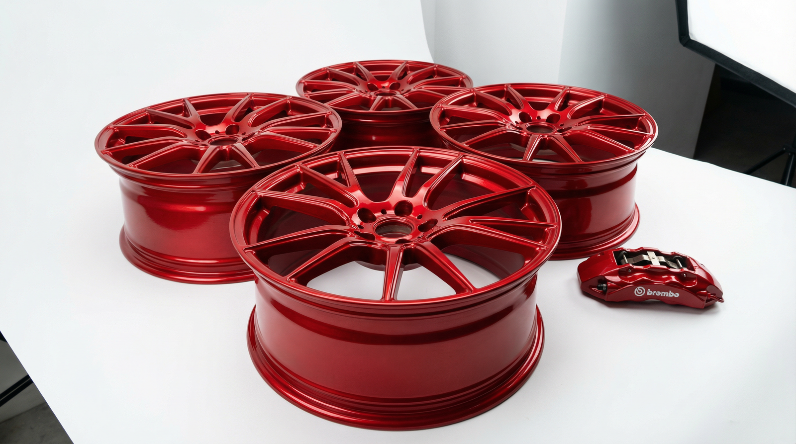 Red powder coated automotive wheels with uniform gloss finish