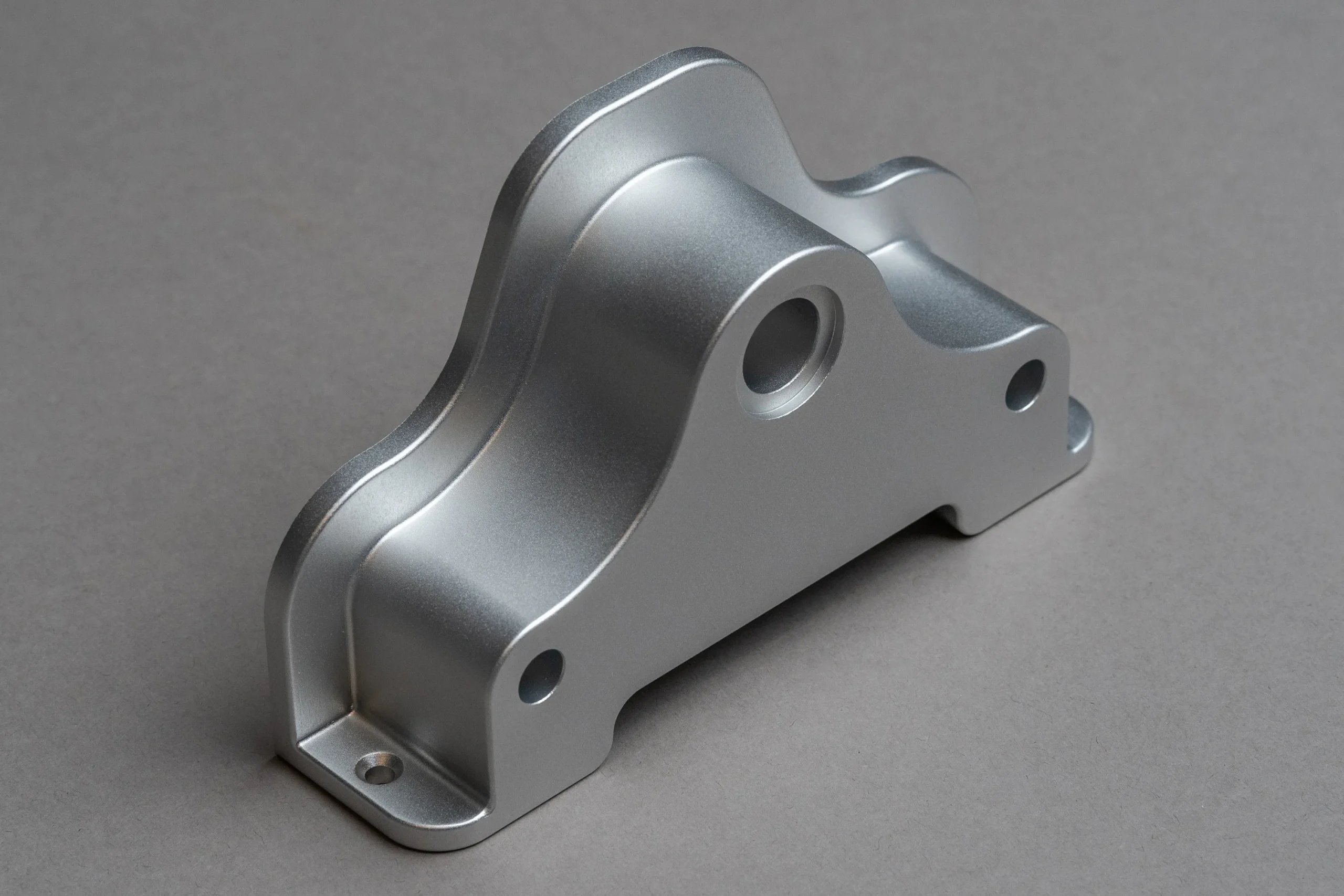 A bead-blasted metal part showing smooth, uniform satin finish