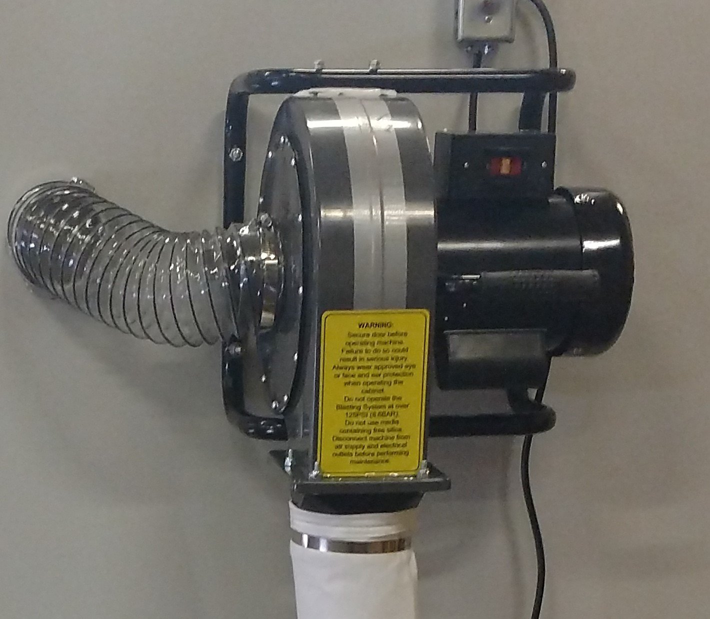 A professional bead blasting cabinet with gloves and viewing window