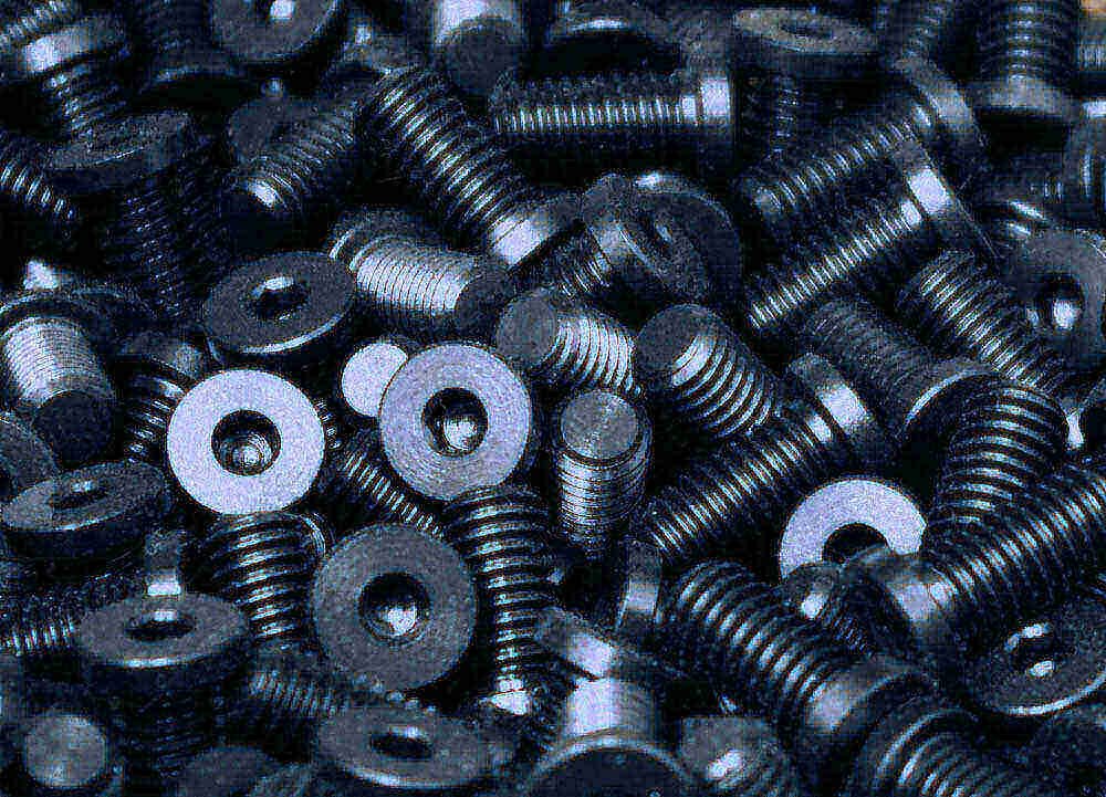 A large batch of black oxide coated screws and fasteners