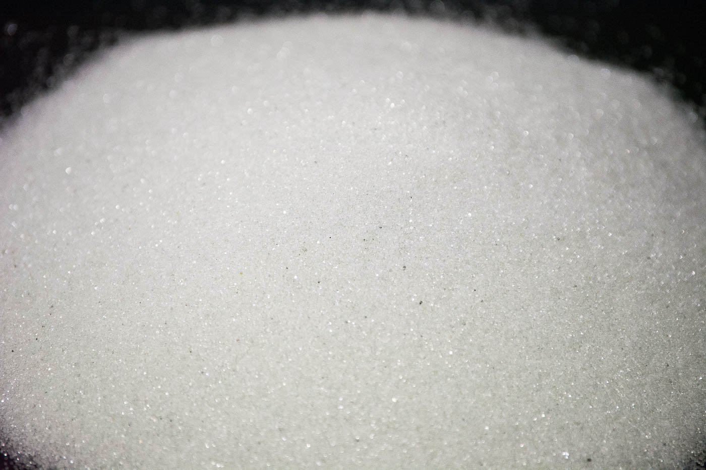 Close-up of glass bead blasting media showing the spherical shape